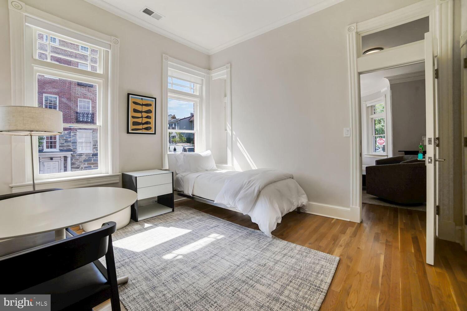 3348 Prospect Street Northwest, Unit 3 Washington, DC 20007 - Photo 9 of 13 a bedroom with a bed and a table in it