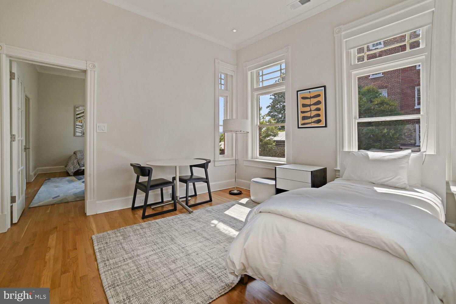 3348 Prospect Street Northwest, Unit 3 Washington, DC 20007 - Photo 10 of 13 a bedroom with a bed and a table in it