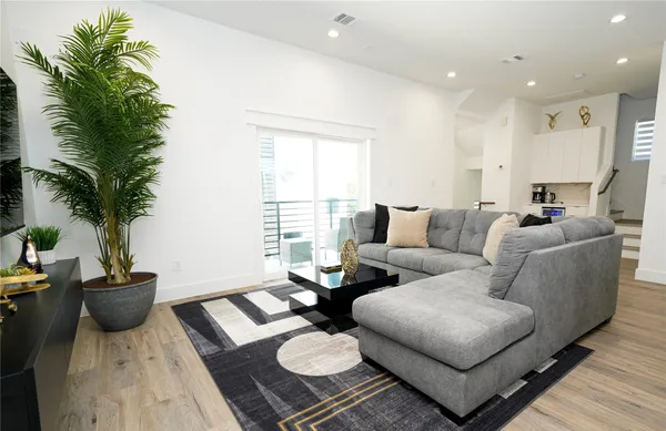 a living room with furniture and a potted plant