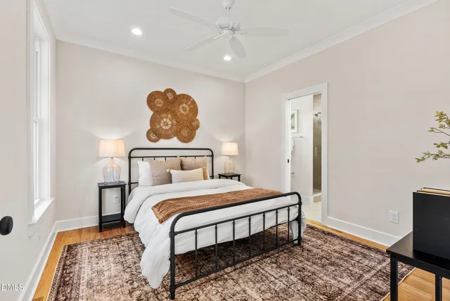 a bedroom with a bed and wooden floor