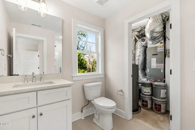 a bathroom with a toilet a sink and a mirror