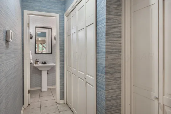 a view of a backyard with chairs potted plants and a large tree