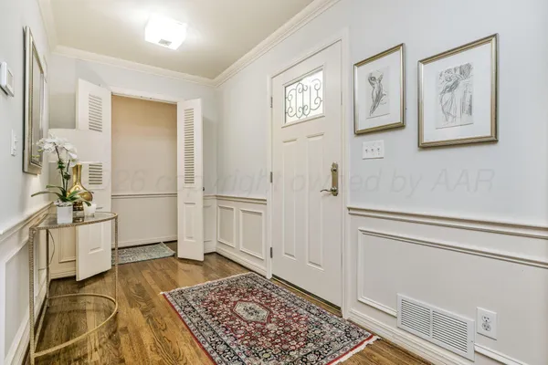 a view of a bedroom with wooden floor and cabinet