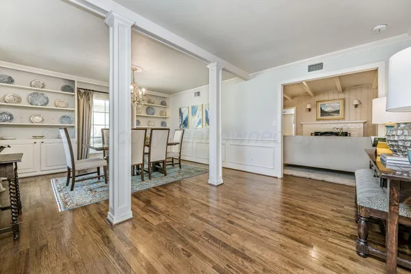 a view of a dining room with furniture and chandelier
