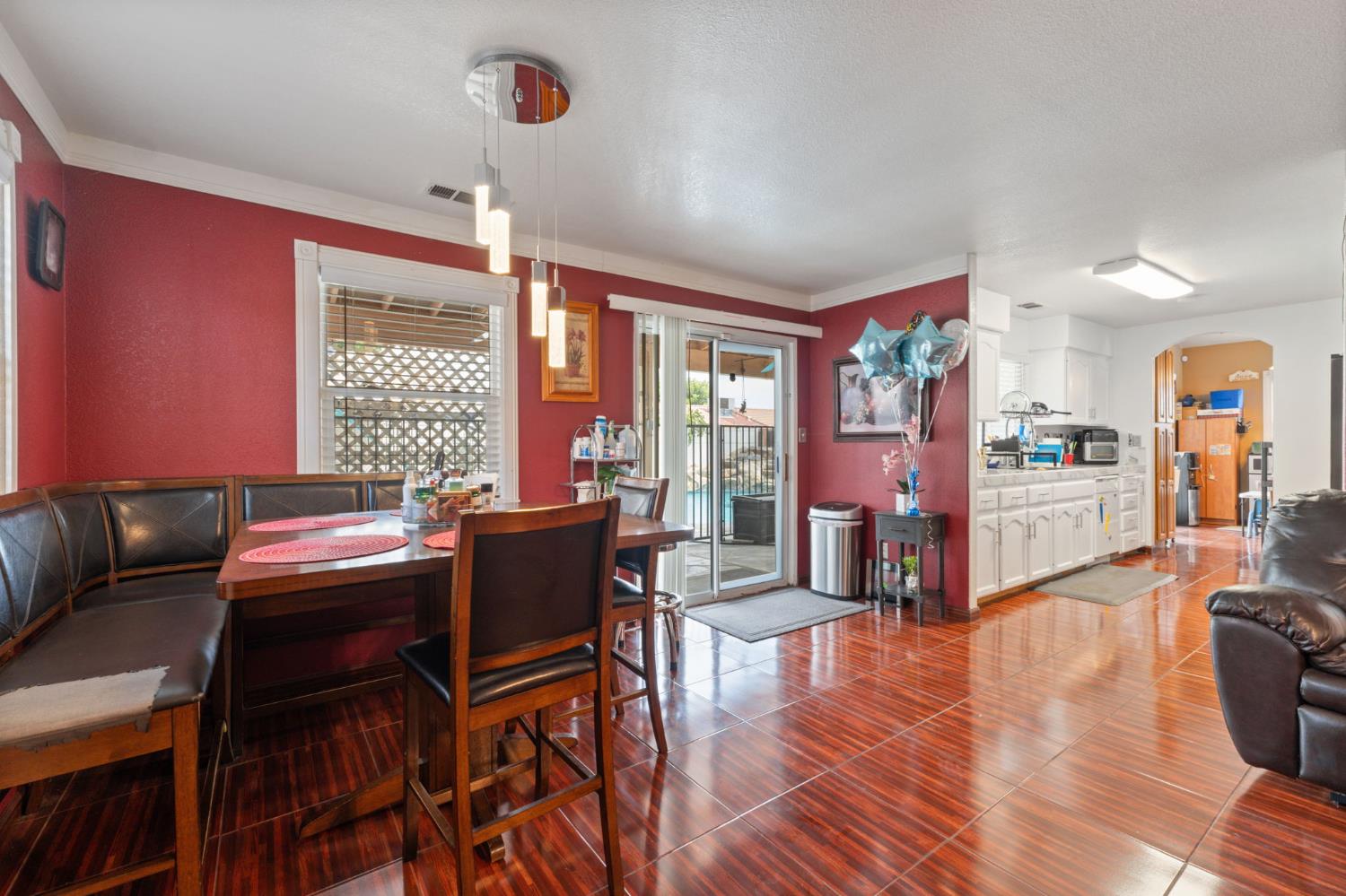 180 Cheney Lane Coalinga, CA 93210 - Photo 14 of 33 a dining room with furniture a chandelier and wooden floor