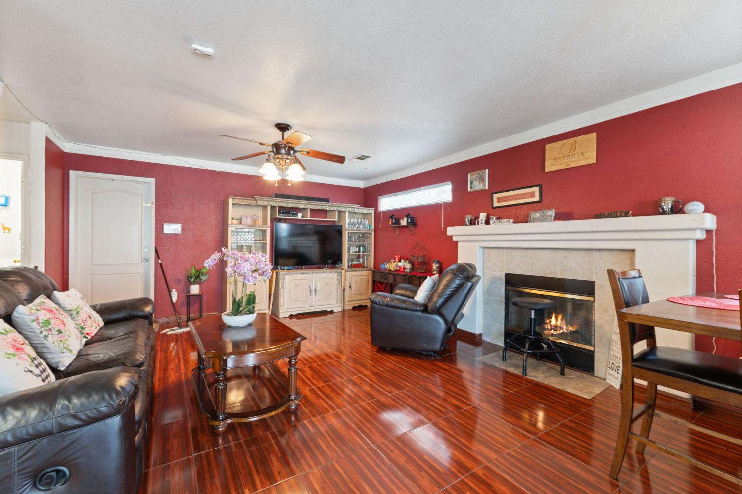 180 Cheney Lane Coalinga, CA 93210 - Photo 15 of 33 a living room with furniture a fireplace and a flat screen tv