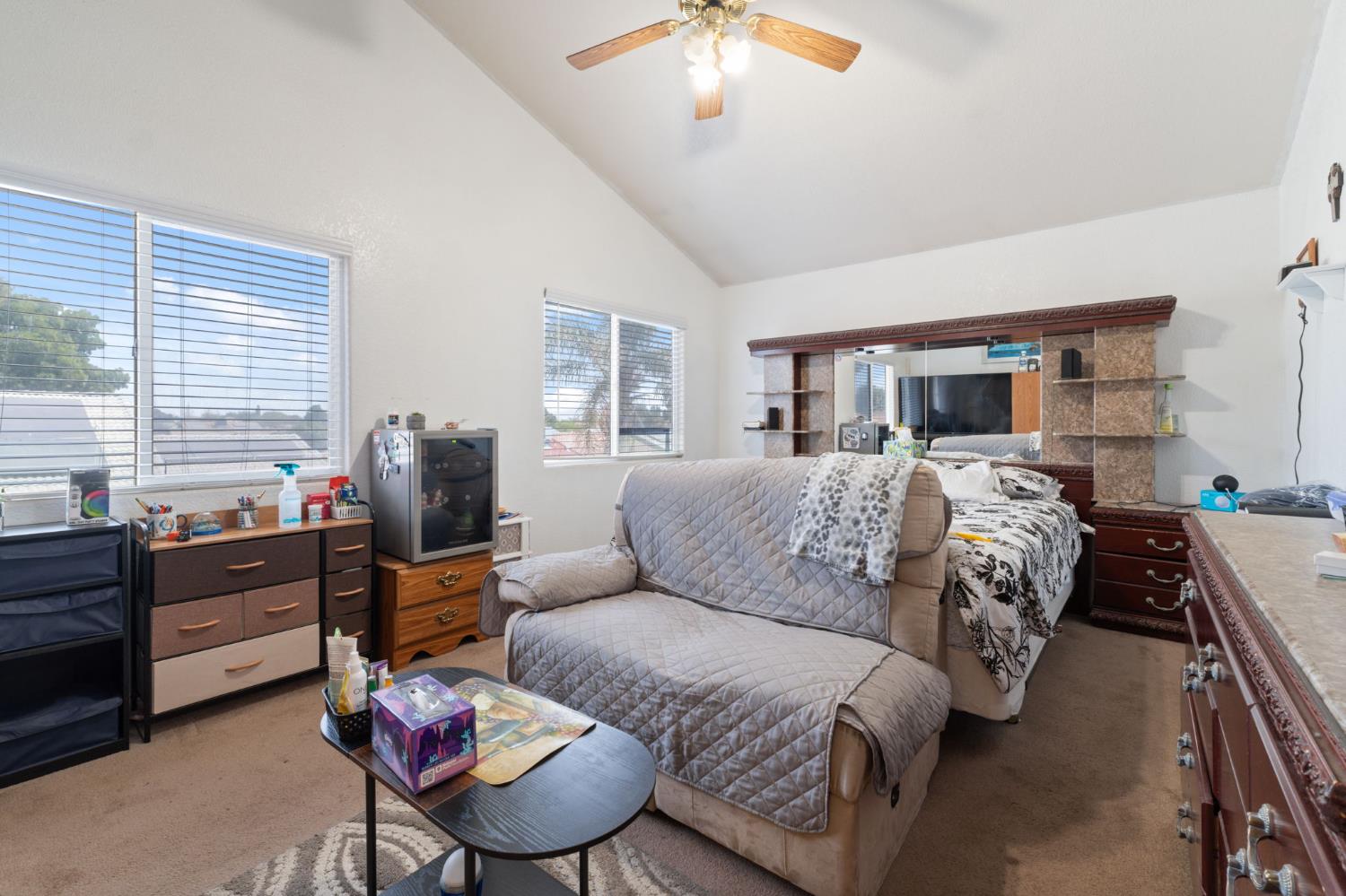 180 Cheney Lane Coalinga, CA 93210 - Photo 23 of 33 a spacious bedroom with a bed a couch and dresser