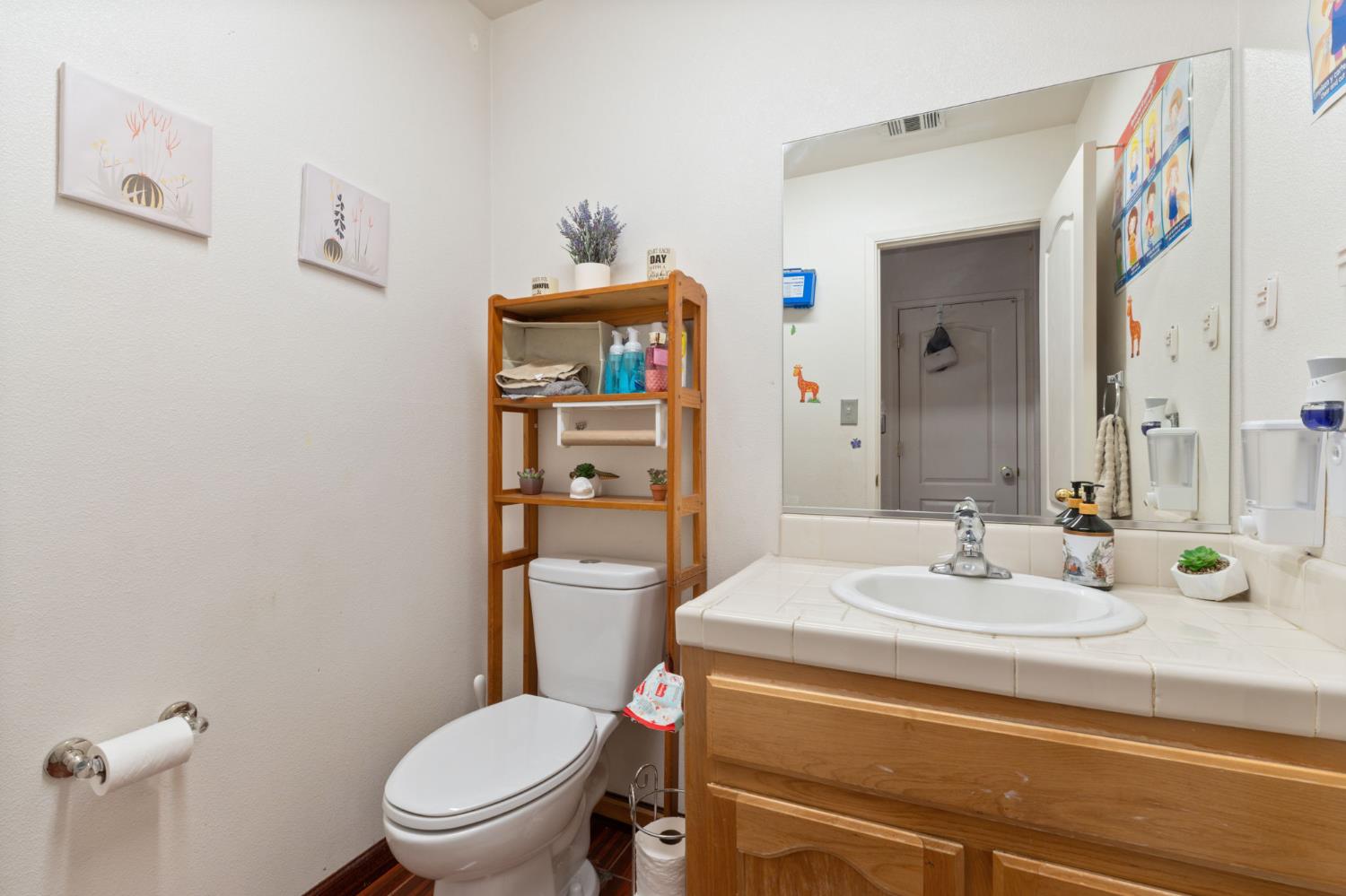 180 Cheney Lane Coalinga, CA 93210 - Photo 26 of 33 a bathroom with a toilet sink and mirror