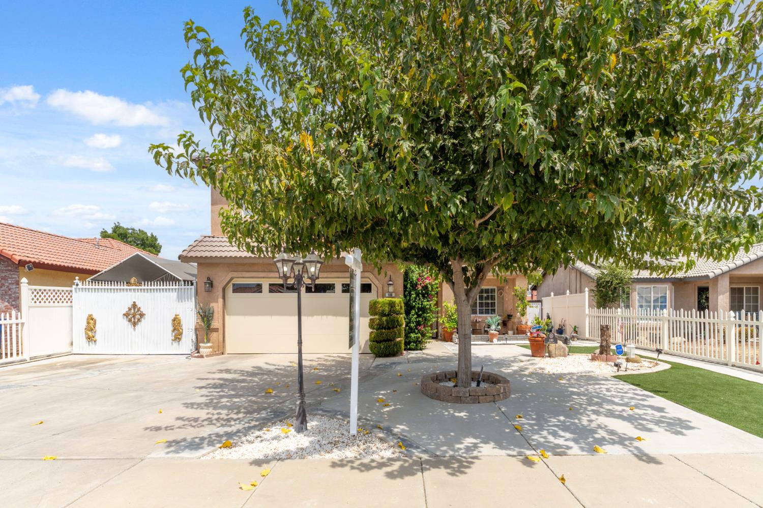 180 Cheney Lane Coalinga, CA 93210 - Photo 3 of 33 a view of a white house next to a yard with big trees
