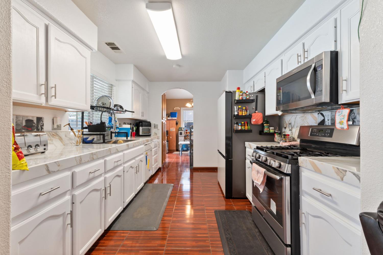 180 Cheney Lane Coalinga, CA 93210 - Photo 5 of 33 a kitchen with stainless steel appliances granite countertop lots of counter top space and cabinets