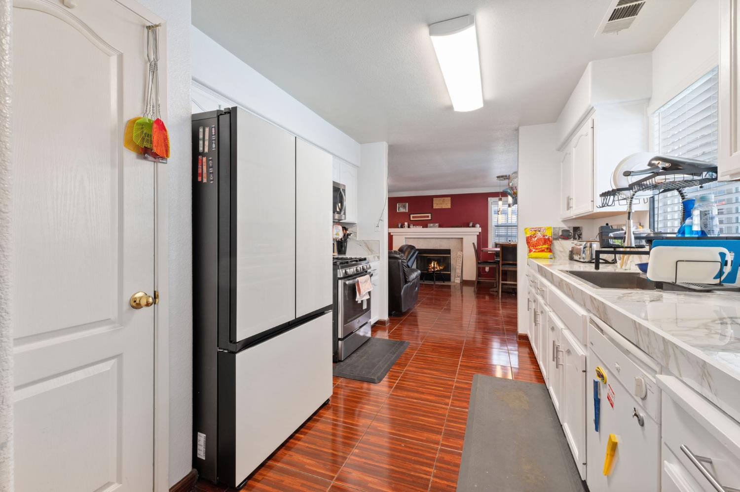 180 Cheney Lane Coalinga, CA 93210 - Photo 7 of 33 a kitchen with stainless steel appliances granite countertop refrigerator and a stove