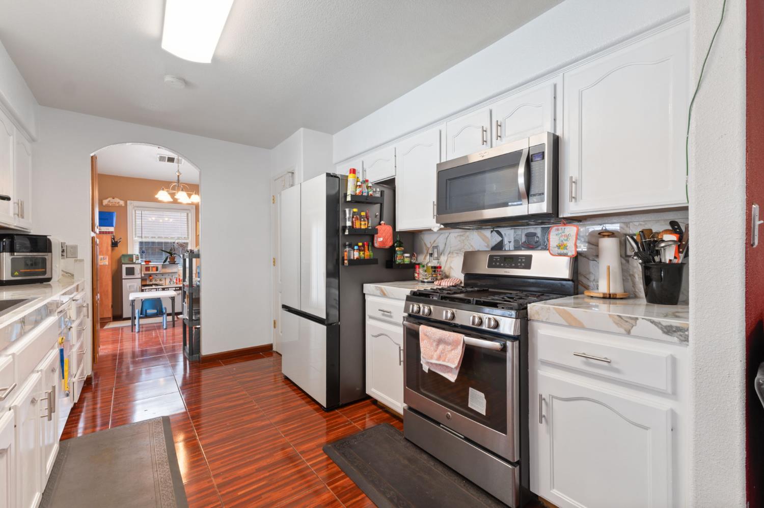 180 Cheney Lane Coalinga, CA 93210 - Photo 8 of 33 a kitchen with stainless steel appliances granite countertop a stove a sink and a microwave