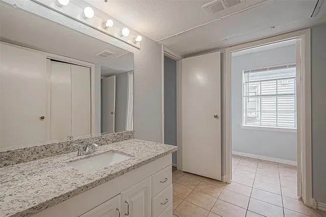 a bathroom with a sink vanity and a mirror