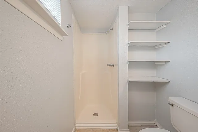 a bathroom with a sink a mirror and a shower