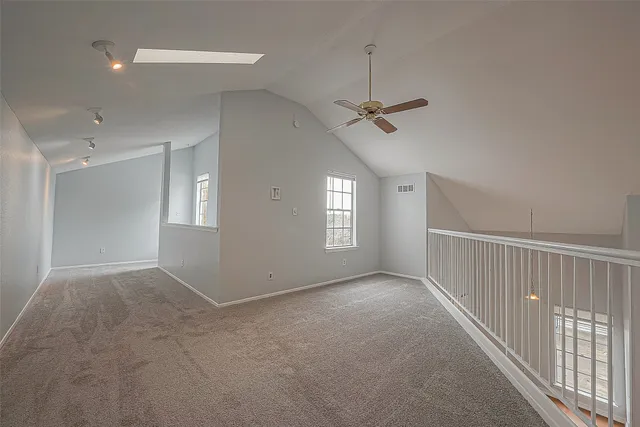 a view of a livingroom with a ceiling fan and window