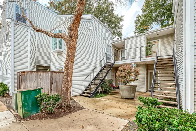 a view of a hallway with wooden floor and a chandelier