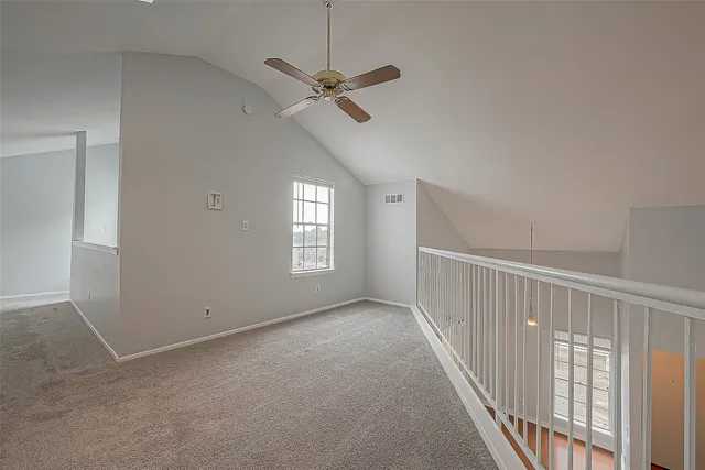 an empty room with staircase and white walls