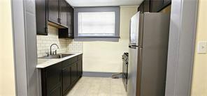 800 Verner Street Northwest Atlanta, GA 30318 - Photo 4 of 8 a bathroom with a sink a mirror and a bathtub