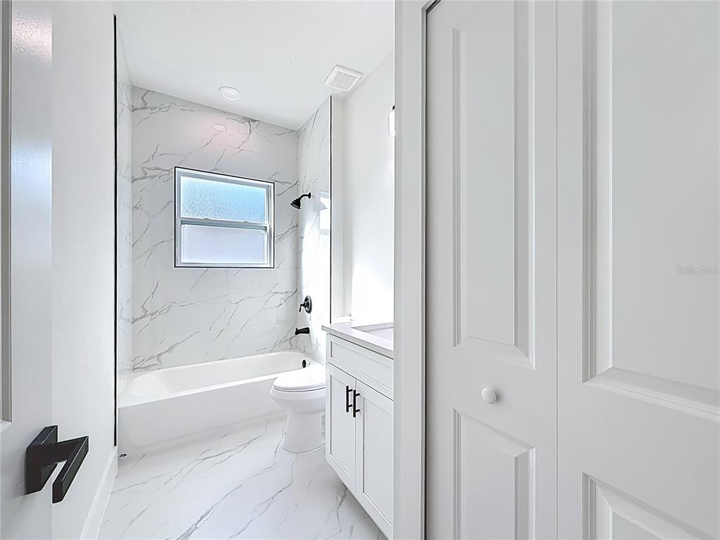8425 North Legacy Loop Citrus Springs, FL 34433 - Photo 34 of 51 a bathroom with a toilet a sink and bathtub