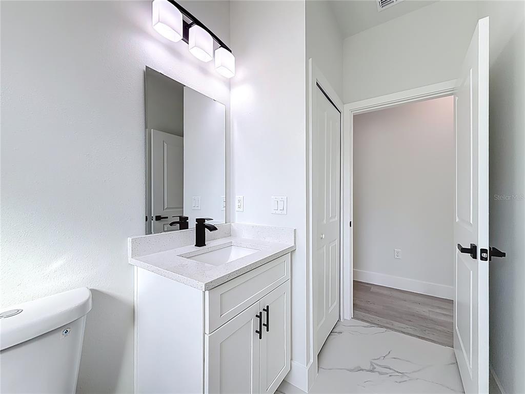 8425 North Legacy Loop Citrus Springs, FL 34433 - Photo 35 of 51 a bathroom with a sink and a mirror