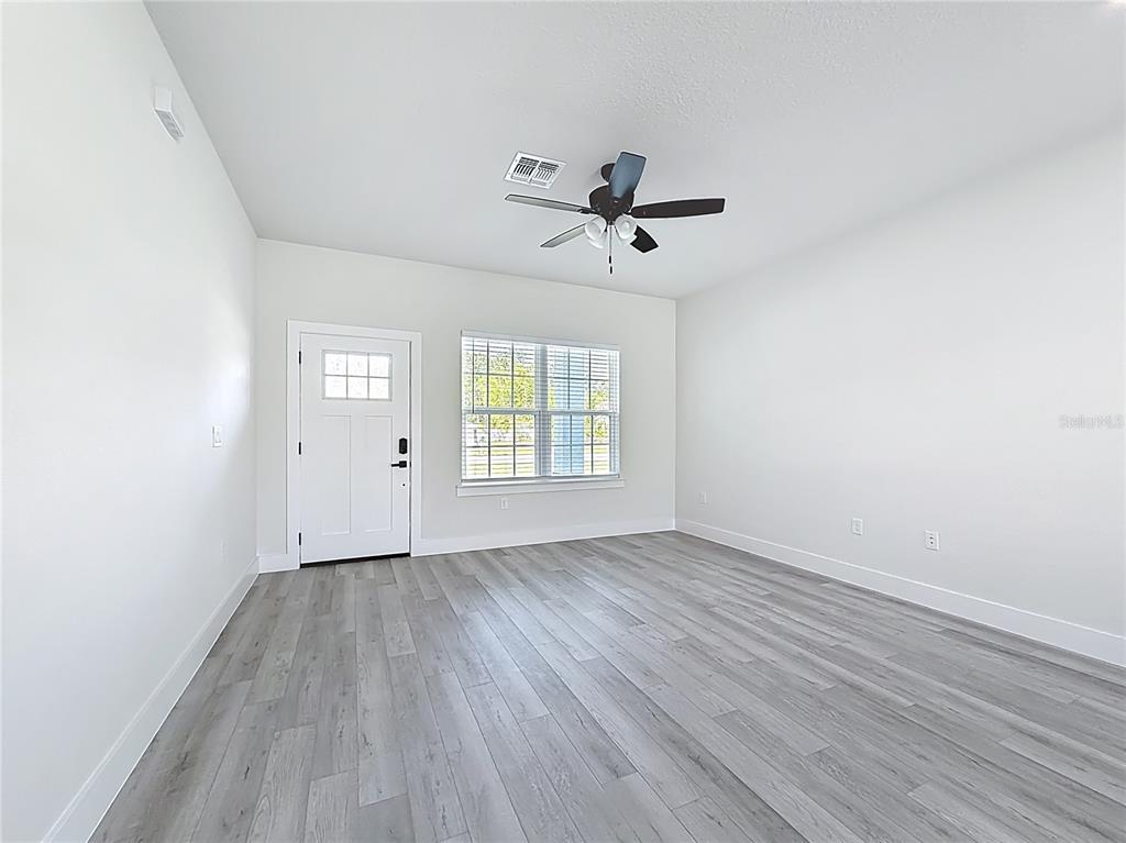 8425 North Legacy Loop Citrus Springs, FL 34433 - Photo 7 of 51 a view of empty room with wooden floor and fan