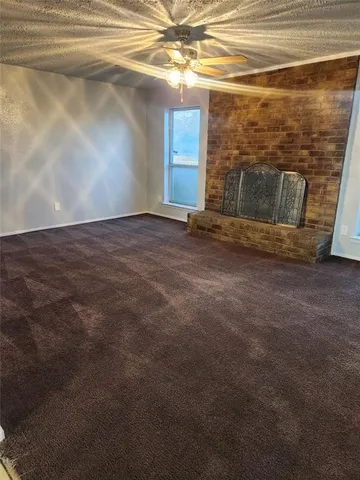 a view of a livingroom with an empty space and a window
