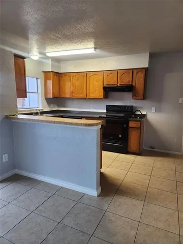 a kitchen with stainless steel appliances a stove a sink and a microwave