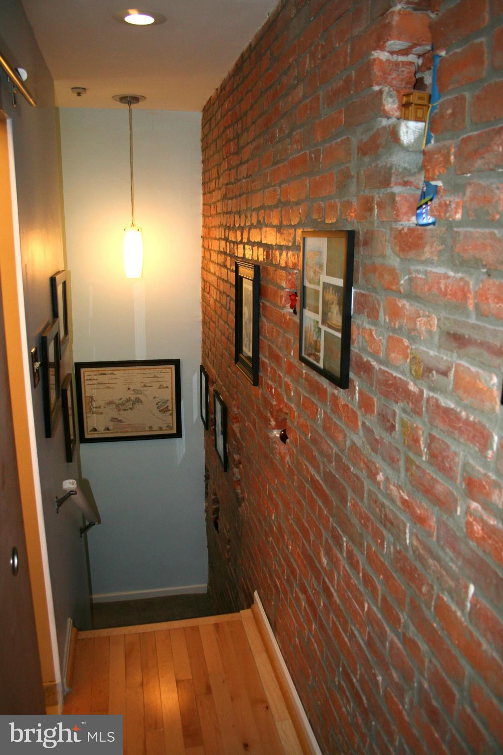 Exposed brick in hallway and stairwell