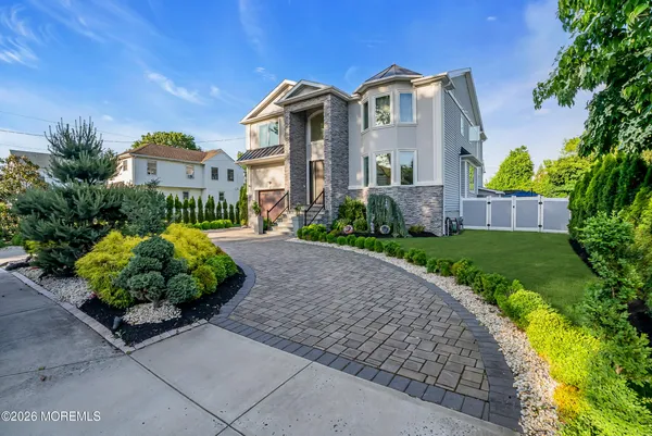 a front view of a house with a garden
