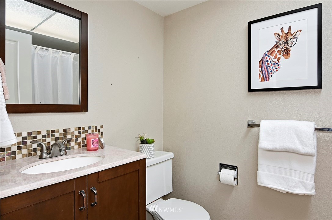 795 South 27th Street Renton, WA 98055 - Photo 11 of 14 a bathroom with a toilet sink and mirror