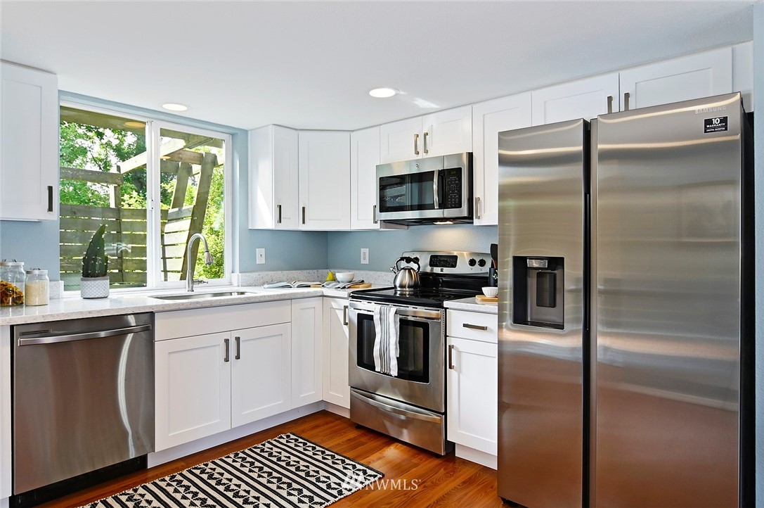 795 South 27th Street Renton, WA 98055 - Photo 5 of 14 a kitchen with stainless steel appliances a refrigerator sink and microwave
