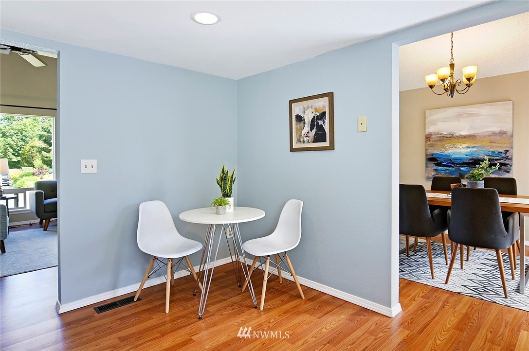 795 South 27th Street Renton, WA 98055 - Photo 6 of 14 a workspace with furniture a chandelier and wooden floor