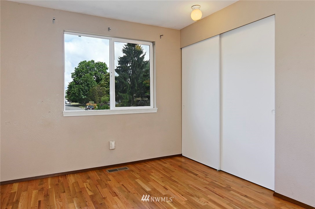 795 South 27th Street Renton, WA 98055 - Photo 10 of 14 a view of an empty room with wooden floor and a window