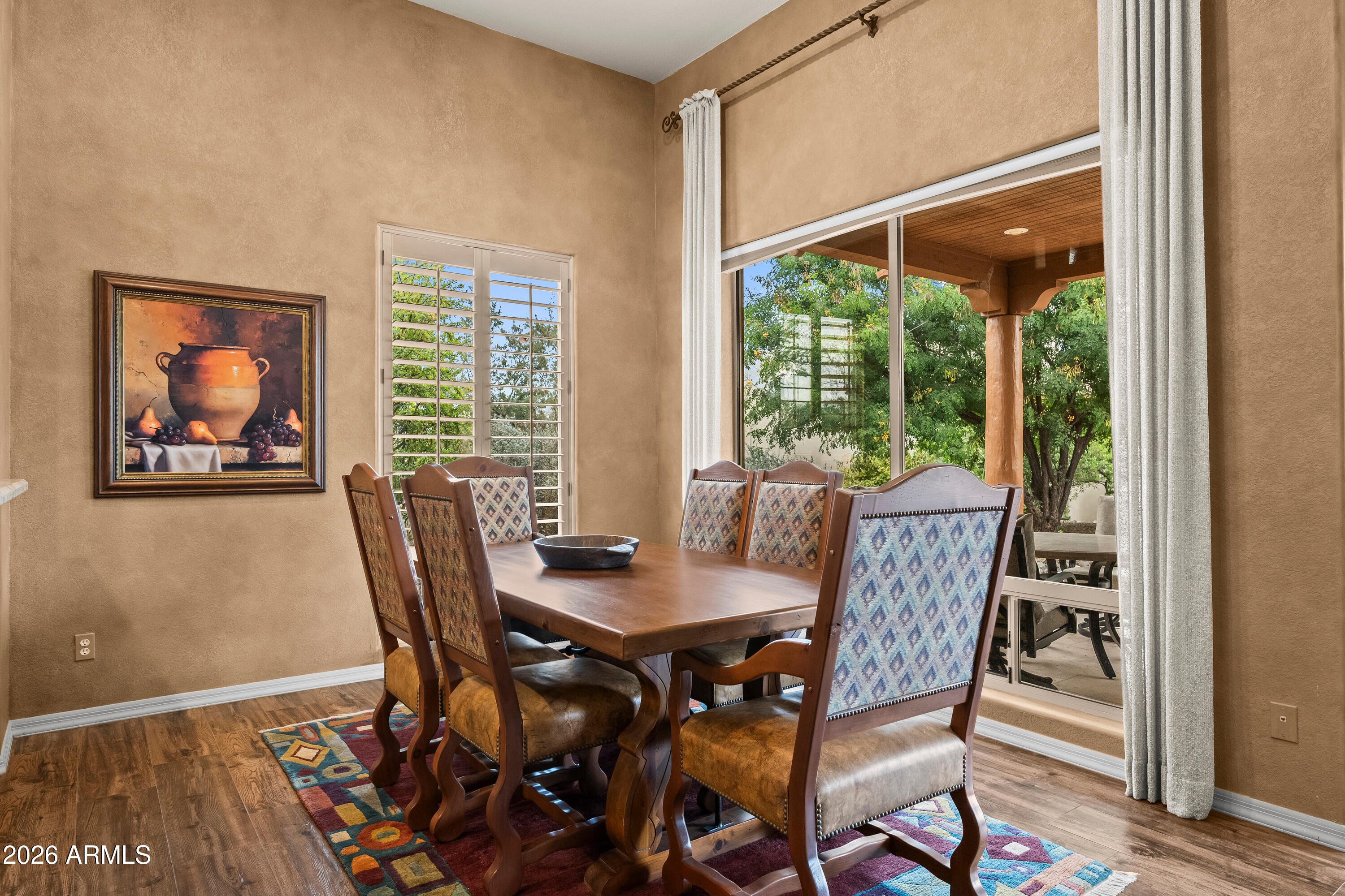 18908 East Quartz Way Rio Verde, AZ 85263 - Photo 11 of 40 a view of a dining room with furniture large windows and wooden floor