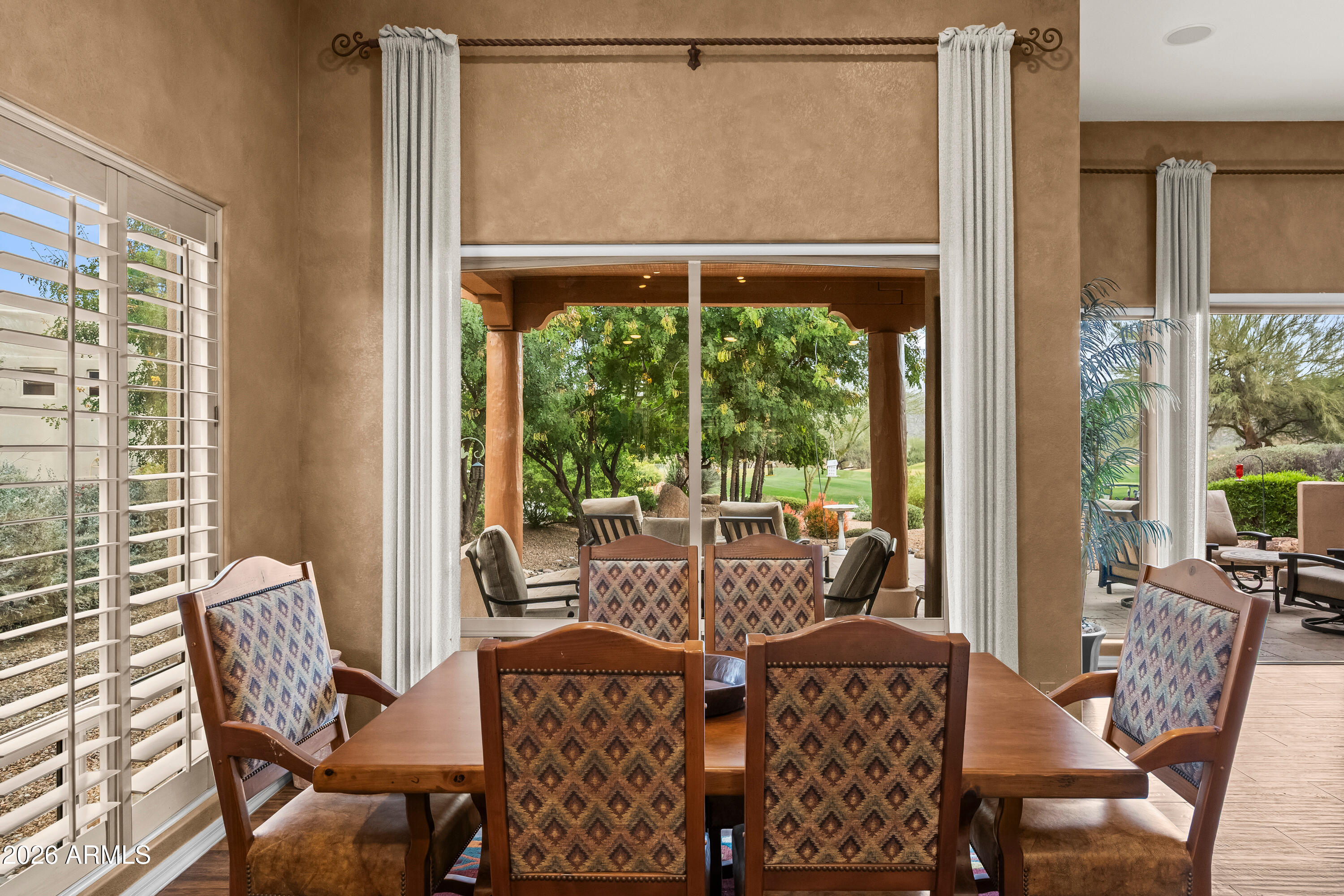 18908 East Quartz Way Rio Verde, AZ 85263 - Photo 12 of 40 a dining room with furniture large windows and wooden floor