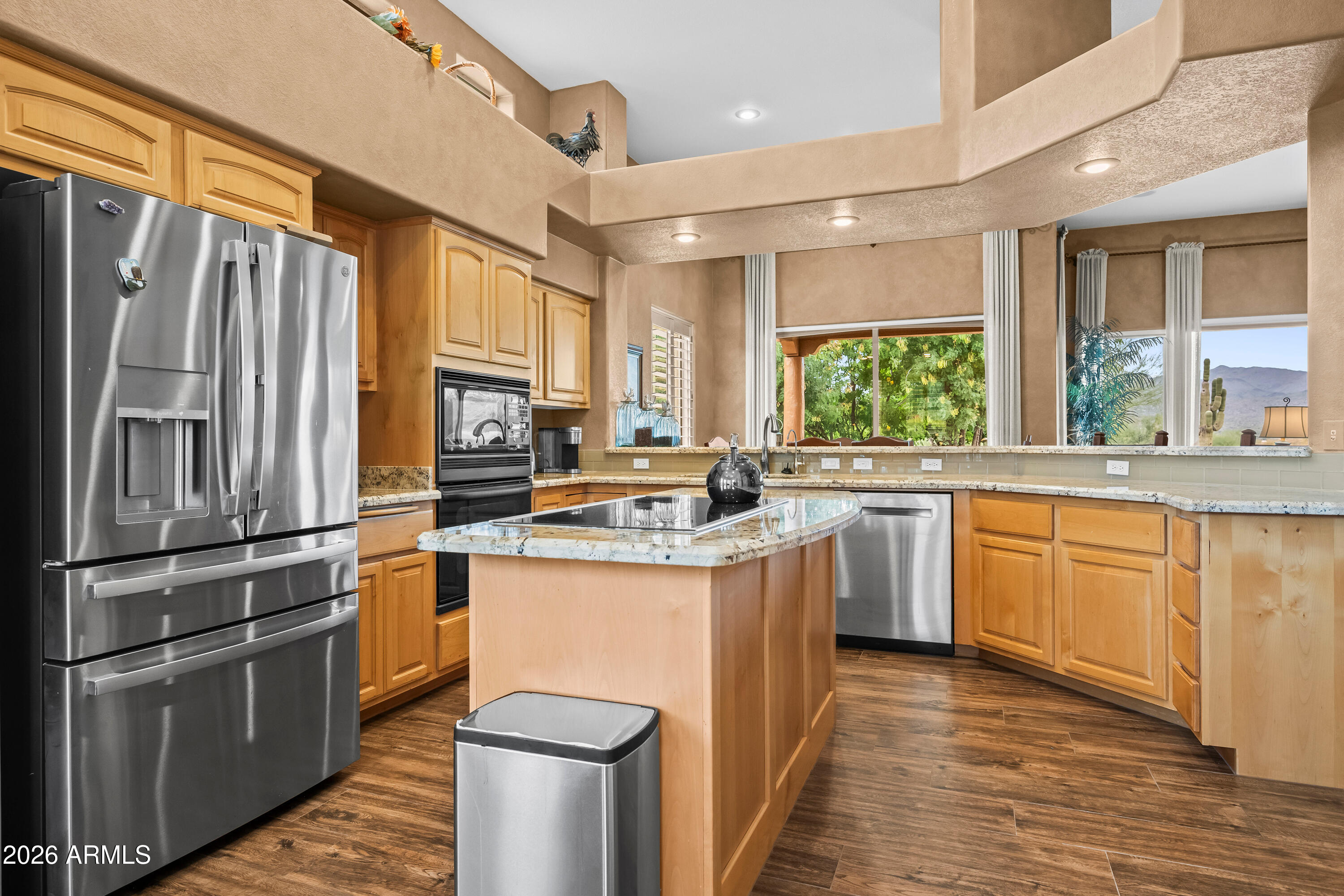 18908 East Quartz Way Rio Verde, AZ 85263 - Photo 14 of 40 a kitchen with kitchen island granite countertop a sink appliances cabinets and a counter top space