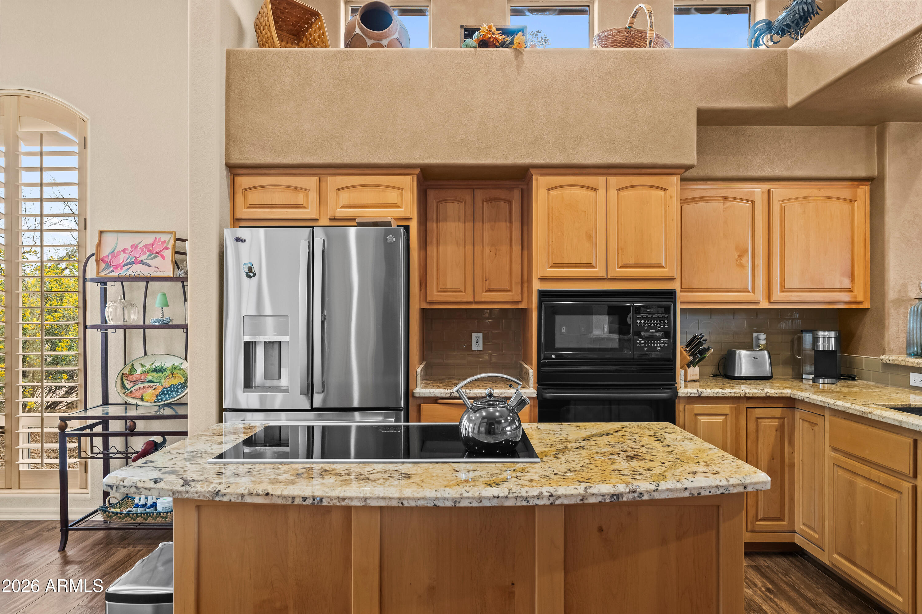 18908 East Quartz Way Rio Verde, AZ 85263 - Photo 16 of 40 a kitchen with stainless steel appliances granite countertop a sink stove and cabinets