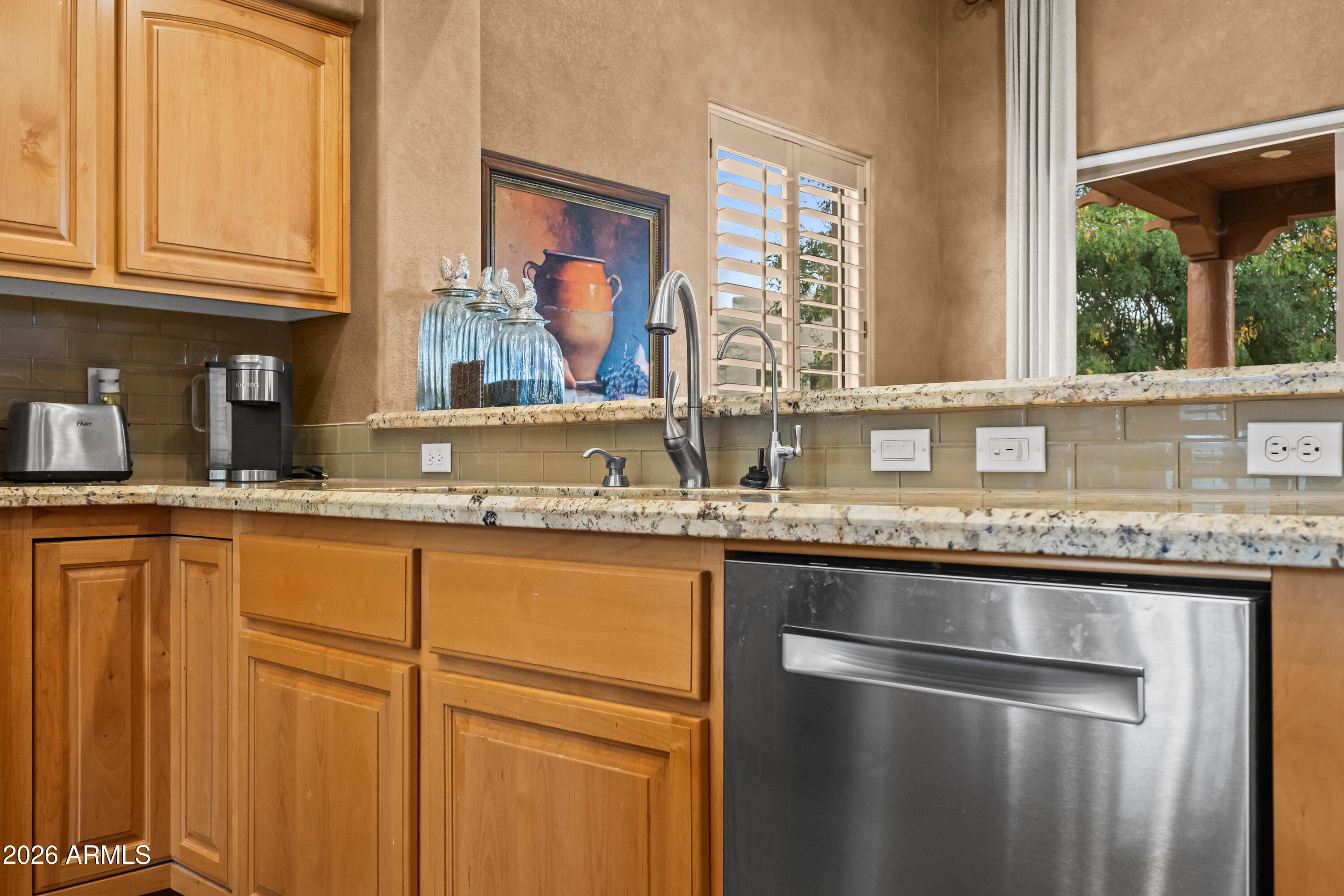 18908 East Quartz Way Rio Verde, AZ 85263 - Photo 17 of 40 a kitchen with stainless steel appliances granite countertop a sink and a window