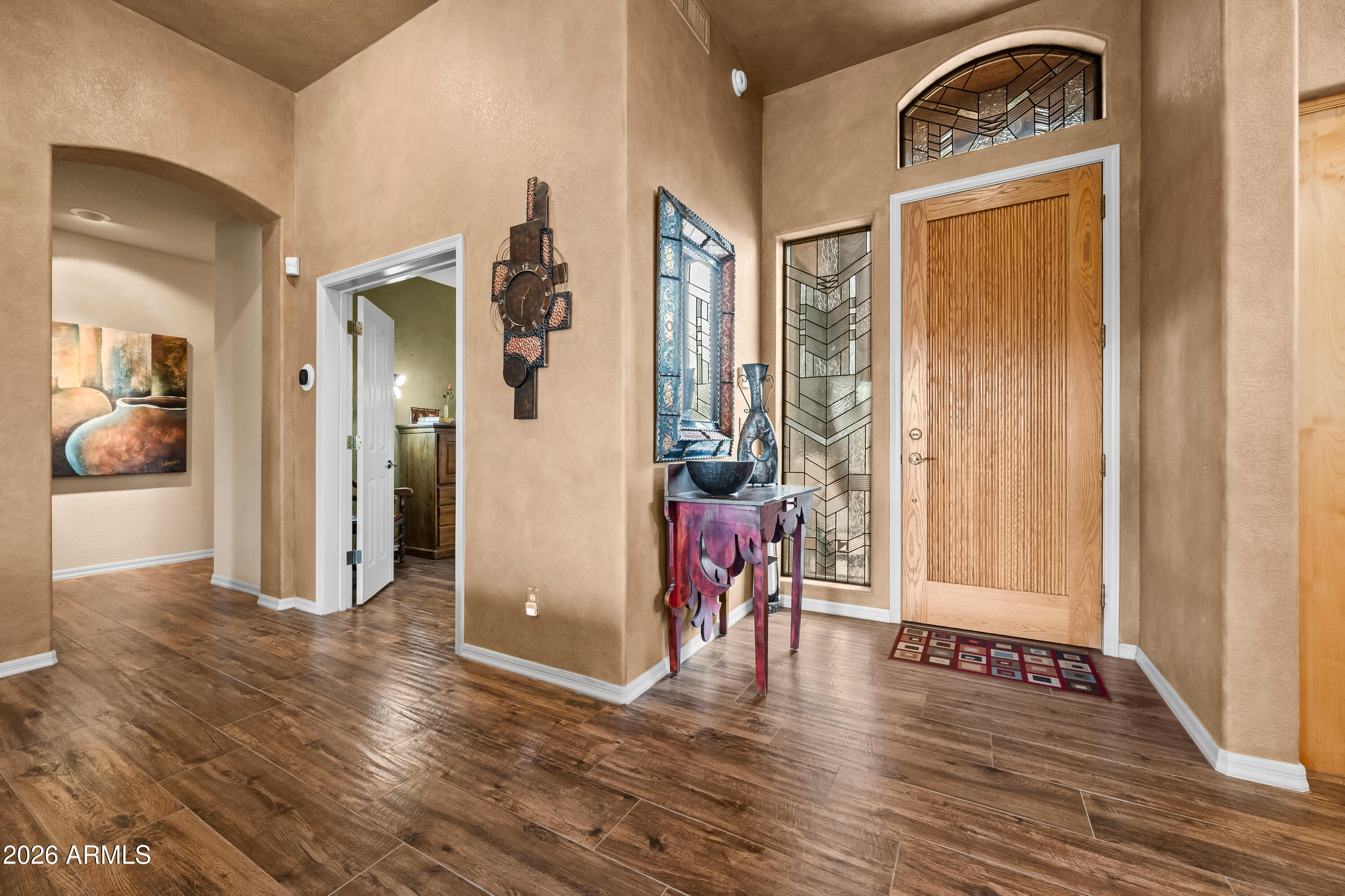 18908 East Quartz Way Rio Verde, AZ 85263 - Photo 6 of 40 a view of a hallway to a livingroom with wooden floor and a window