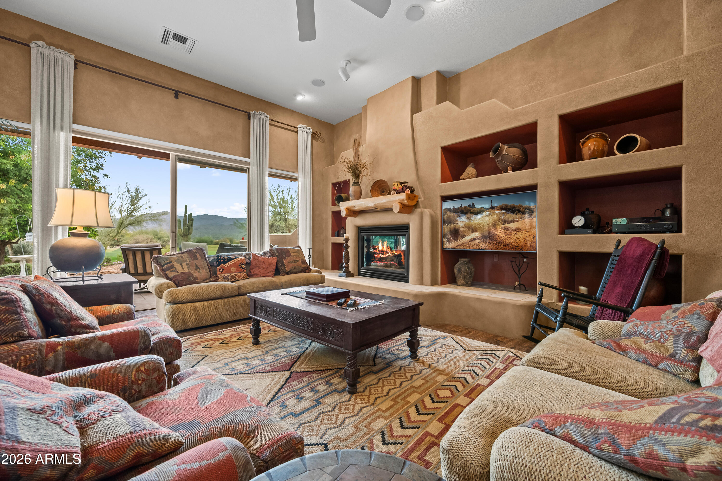 18908 East Quartz Way Rio Verde, AZ 85263 - Photo 9 of 40 a living room with furniture a rug and a large window