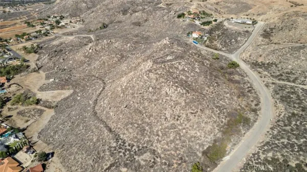 a view of a dry yard and mountain view