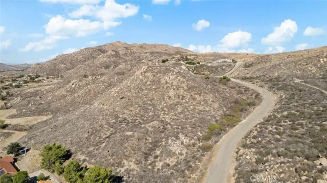 a view of a dry yard with trees
