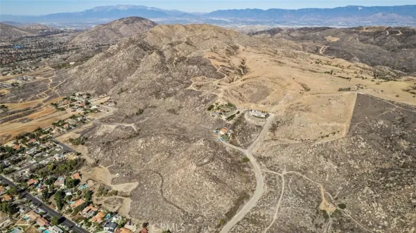 a view of a dry yard with mountains in the background