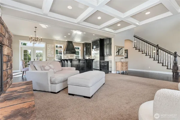 a living room with furniture and a dining table with kitchen view