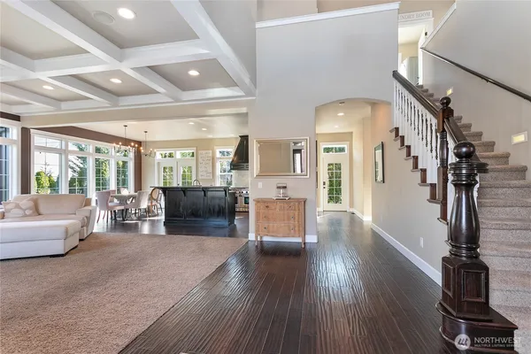 a living room with lots of furniture and wooden floors