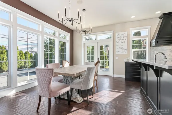 a view of a dining room with furniture large windows and wooden floor
