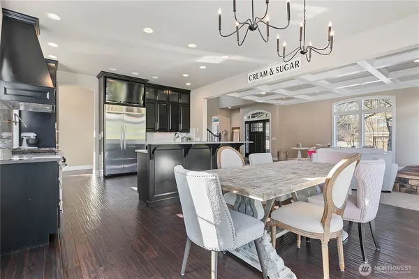 a large kitchen with a table and chairs