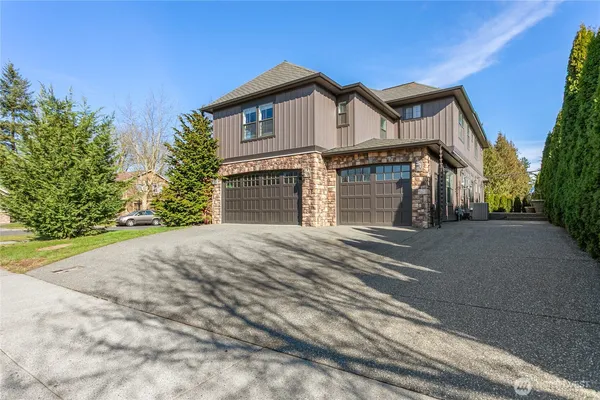 a view of a house with a yard and garage