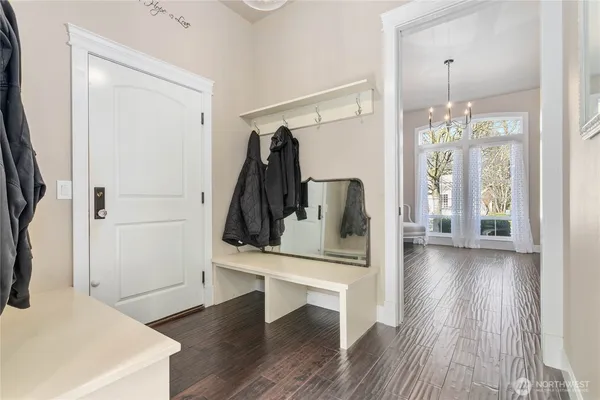 a view of a hallway with wooden floor and entryway