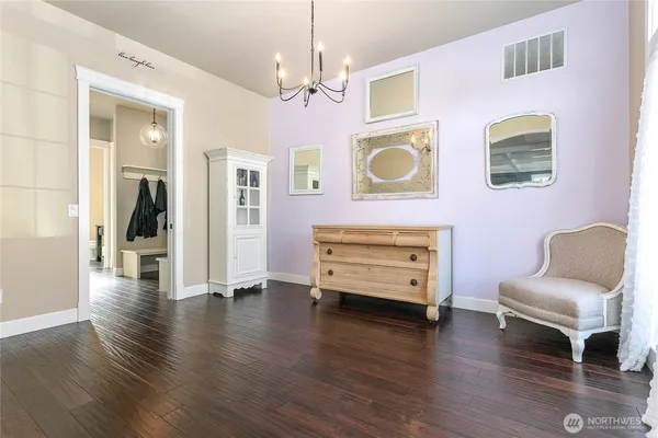 a view of a livingroom with furniture wooden floor and windows